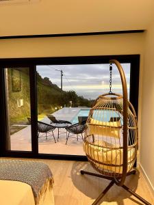 a bird cage in a room with a view of a patio at Balcobo Villas&Cabañas in A Coruña +148 photos