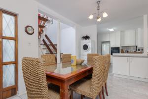 a kitchen and dining room with a table and chairs at Unit 4 Springvale in Zinkwazi Beach