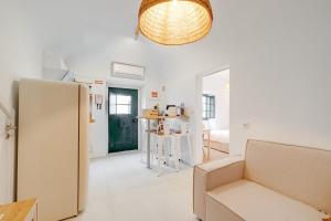 a living room with a couch and a refrigerator at Casa Do Beco in Moura