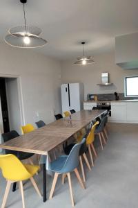 a dining room with a large wooden table and chairs at Gîte de Briante in Saint-Lager
