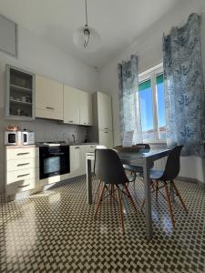 a kitchen with a table and two chairs in it at Il Pesce di Legno in Livorno