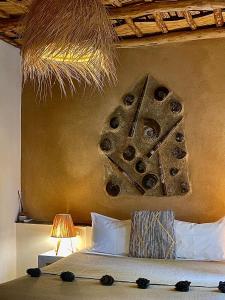 a bedroom with a bed with aigraphy on the wall at Manzil La Tortue in Douar Caïd Layadi +100 photos