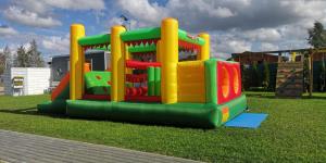 a childrens playground with a play structure on the grass at WAKACYJNE ZAGAJE in Sarbinowo