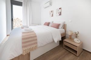 biała sypialnia z łóżkiem i oknem w obiekcie Stylish spacious apartment in Palaio Faliro (C1) w Atenach