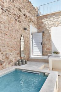 a pool in a room with a brick wall at Orange Tree House in Vis