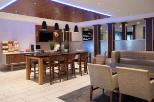 a dining room and kitchen with a table and chairs at Holiday Inn Express Sheboygan-Kohler / I-43 by IHG in Sheboygan