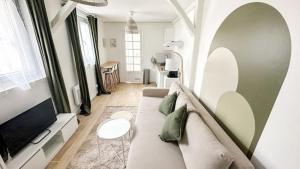 a living room with a couch and a table at Emmanuel INN 2 in Pierrefitte-sur-Seine