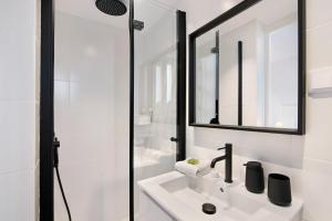 a white bathroom with a sink and a shower at Apartamento Balaia Praia in Albufeira +33 photos