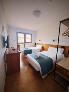Postel nebo postele na pokoji v ubytování Hostal Legaz