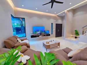 un salon avec deux canapés et une télévision à écran plat dans l'établissement JPP l 角头间豪华私人KTV房泳池Switch火锅炉BBQ麻将机可睡26人5分钟到Austin, à Johor Bahru