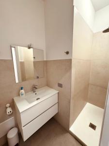 a white bathroom with a sink and a shower at La Maison de la Dame in Matera +32 photos