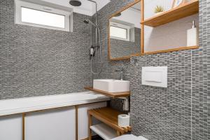 a bathroom with a sink and a mirror at Cozy Apartment - Swimming Center, Airport & Therme SPA in Otopeni +15 photos