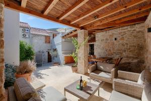 an outdoor patio with a wooden pergola at House Corte in Vis