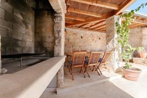 a patio with two chairs and a table on a porch at House Corte in Vis