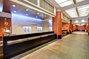 a large lobby with a waiting area with photographs on the wall at Embassy Suites by Hilton Chicago Downtown Magnificent Mile in Chicago