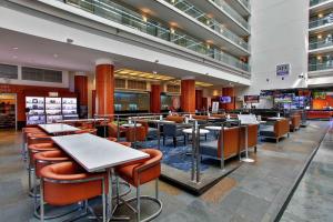a restaurant with tables and chairs in a mall at Embassy Suites by Hilton Chicago Downtown Magnificent Mile in Chicago +37 photos