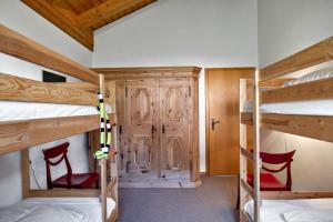 a room with two bunk beds and a hallway at Chesa Panorama B - La Punt in La Punt-Chamues-ch