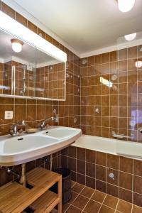 a bathroom with a sink and a tub at Chesa Panorama B - La Punt in La Punt-Chamues-ch +19 photos