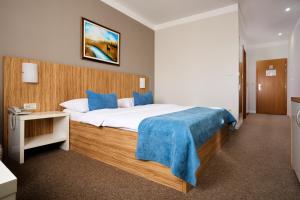 Posteľ alebo postele v izbe v ubytovaní Hotel Phoenix