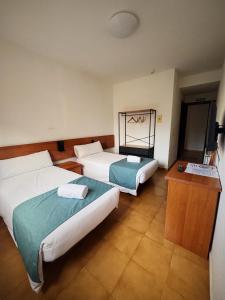 Postel nebo postele na pokoji v ubytování Hostal Legaz