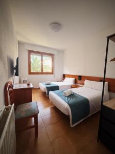 Postel nebo postele na pokoji v ubytování Hostal Legaz
