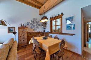 a dining room with a table and a couch at Chesa Roseg - Pontresina in Pontresina
