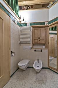 a bathroom with a toilet and a bidet and a sink at Chesa Roseg - Pontresina in Pontresina +29 photos
