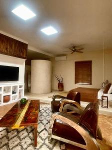 a living room with a couch and a table at Manzil La Tortue in Douar Caïd Layadi