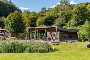 a log cabin in the middle of a field at Yorkshire Dales Lodge 4 Family 3 Bed in Richmond