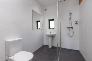 a white bathroom with a toilet and a sink at Yorkshire Dales Lodge 4 Family 3 Bed in Richmond +17 photos