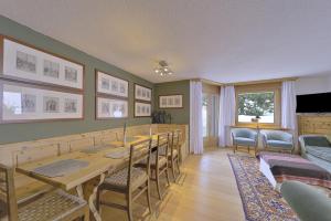 a dining room with a long table and chairs at Chesa Rosatsch - Bever in Bever