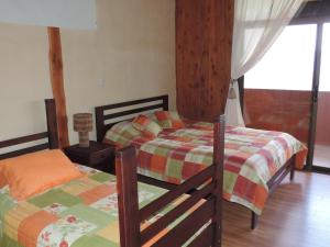 Postel nebo postele na pokoji v ubytování Quinta Galeon Lodge