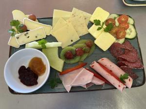 a tray of different types of cheese and meats at Strandperle in Schwielowsee