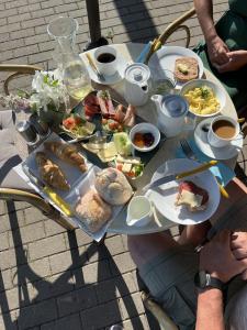 a table with plates of food on it at Strandperle B&B in Schwielowsee