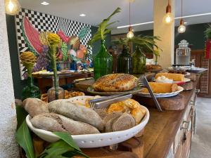a buffet with bread and other food on a table at Maria Barbosa Tiradentes Pousada e Spa in Tiradentes