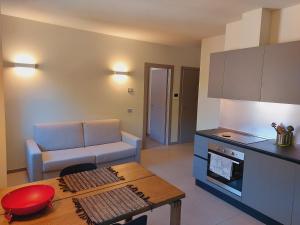 a kitchen and living room with a table and a couch at The 6 apartments S in Rimini