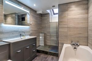 a bathroom with a tub and a sink and a shower at Finest Retreats - Whitley in Molland +51 photos