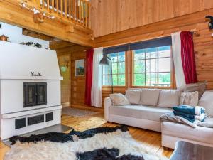 un salon avec un canapé et une cheminée dans l'établissement Holiday Home Hietaniemen usko by Interhome, à Sonkajärvi