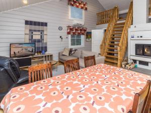 a dining room and living room with a table and chairs at Holiday Home Onnimanni by Interhome in Kuusamo