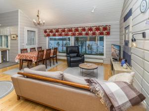 a living room with a couch and a table at Holiday Home Onnimanni by Interhome in Kuusamo