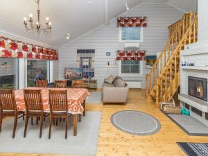 a dining room with a table and a fireplace at Holiday Home Onnimanni by Interhome in Kuusamo