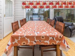 a dining room table with a orange and white table cloth at Holiday Home Onnimanni by Interhome in Kuusamo +33 photos