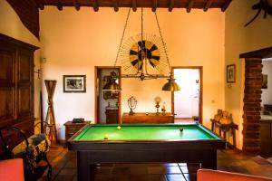 a living room with a pool table and a clock at Quinta do Céu Tranquilidade e Piscina no Alentejo in Alvito