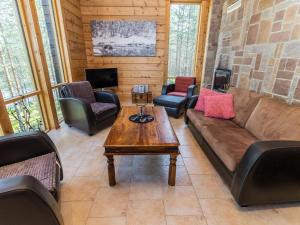 a living room with a couch and chairs and a table at Holiday Home Matkajoentie 4b by Interhome in Kuusamo