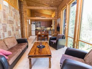 a living room with a couch and a table at Holiday Home Matkajoentie 4b by Interhome in Kuusamo