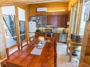 a kitchen with a long wooden table in a room at Holiday Home Matkajoentie 4b by Interhome in Kuusamo