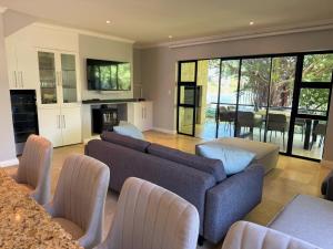 a living room with two couches and a fireplace at Pearl Valley family golf lodge on nature lake with mountain views in Simondium