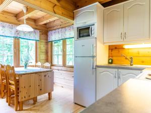 una cucina con un frigorifero bianco e un tavolo di Holiday Home Strandkulla 7 by Interhome a Närpiö