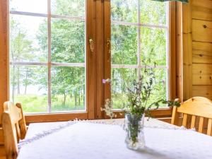 un tavolo con un vaso con dei fiori sopra di Holiday Home Strandkulla 7 by Interhome a Närpiö