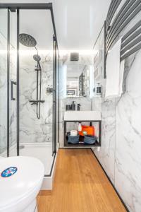 a bathroom with a shower and a toilet and a sink at The Homeboat Company Albufeira in Albufeira +37 photos